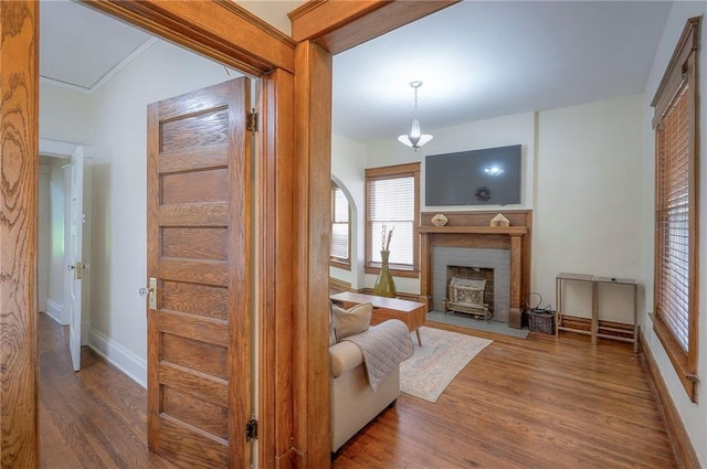 3923 Campbell St, Kansas City, MO 64110 - living area with wood finished floors and a fireplace with flush hearth