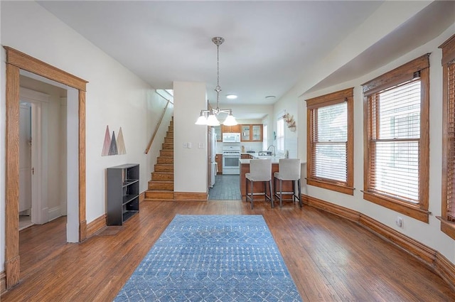 3923 Campbell St, Kansas City, MO 64110 - dining space featuring plenty of natural light, stairway, and dark wood-style floors