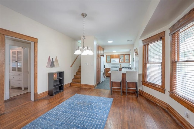 3923 Campbell St, Kansas City, MO 64110 - dining space with dark wood-type flooring, stairway, a chandelier, and recessed lighting