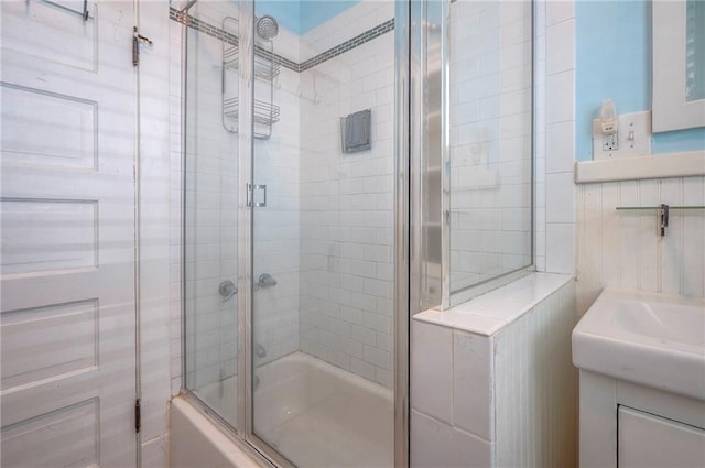 3923 Campbell St, Kansas City, MO 64110 - bathroom featuring combined bath / shower with glass door and vanity