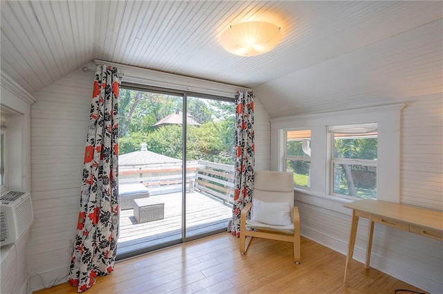 3923 Campbell St, Kansas City, MO 64110 - sitting room featuring lofted ceiling, light wood-style floors, healthy amount of natural light, and wood walls