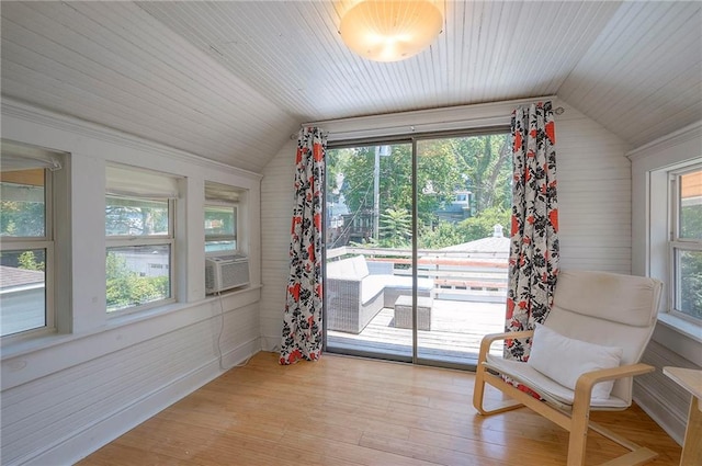 3923 Campbell St, Kansas City, MO 64110 - living area with lofted ceiling, wooden walls, light wood-style floors, wood ceiling, and cooling unit