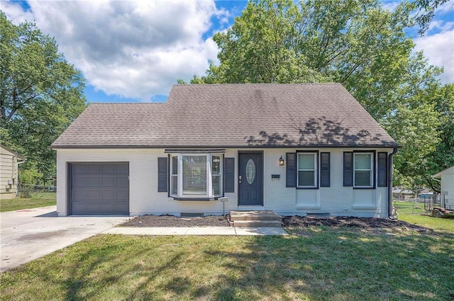 611 Pawnee Ln, Belton, MO 64012 - view of front of house with an attached garage, brick siding, concrete driveway, and roof with shingles
