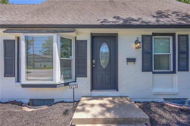 611 Pawnee Ln, Belton, MO 64012 - entrance to property with brick siding and a shingled roof