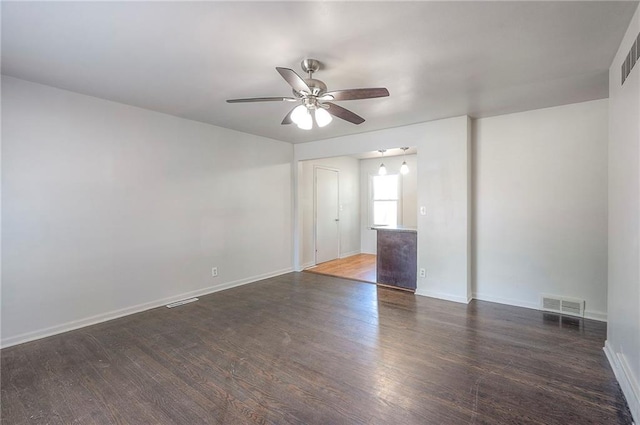 611 Pawnee Ln, Belton, MO 64012 - empty room with a ceiling fan and dark wood-style floors