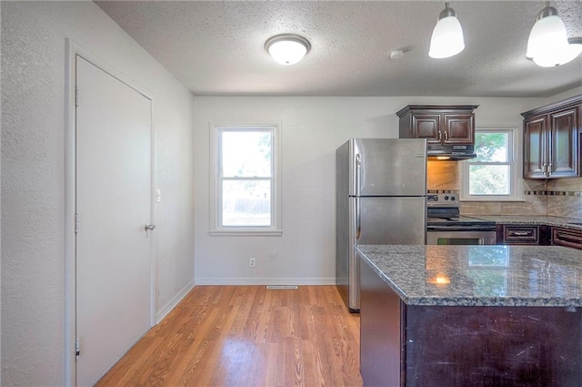 611 Pawnee Ln, Belton, MO 64012 - kitchen with stainless steel appliances, under cabinet range hood, light wood-type flooring, dark brown cabinetry, and a textured ceiling