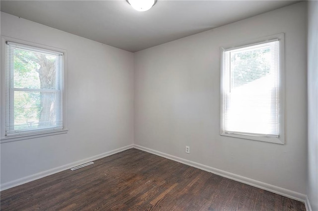 611 Pawnee Ln, Belton, MO 64012 - empty room featuring dark wood-style floors and baseboards