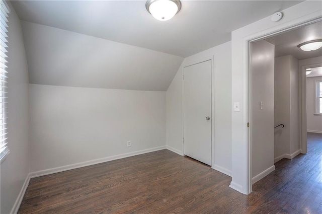 611 Pawnee Ln, Belton, MO 64012 - additional living space with dark wood-style floors and lofted ceiling