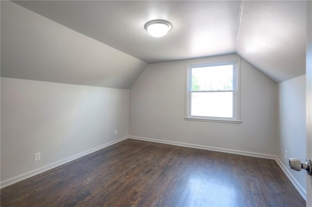 611 Pawnee Ln, Belton, MO 64012 - bonus room featuring dark wood-style floors and lofted ceiling