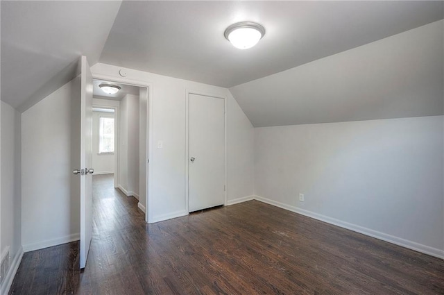 611 Pawnee Ln, Belton, MO 64012 - additional living space with dark wood-type flooring and lofted ceiling