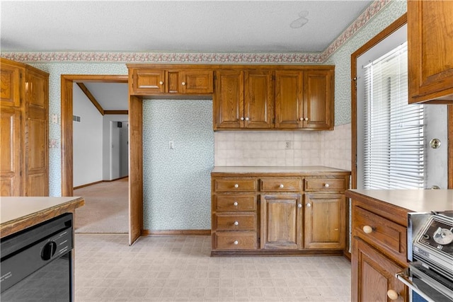 2117 Parker Ct, Blue Springs, MO 64015 - kitchen featuring wallpapered walls, brown cabinetry, light countertops, light floors, and range