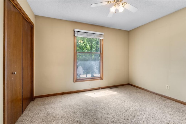 2117 Parker Ct, Blue Springs, MO 64015 - unfurnished bedroom featuring carpet, a closet, a textured ceiling, and ceiling fan