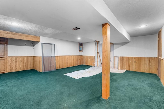 2117 Parker Ct, Blue Springs, MO 64015 - finished below grade area with wood walls, carpet, a wainscoted wall, and a textured ceiling