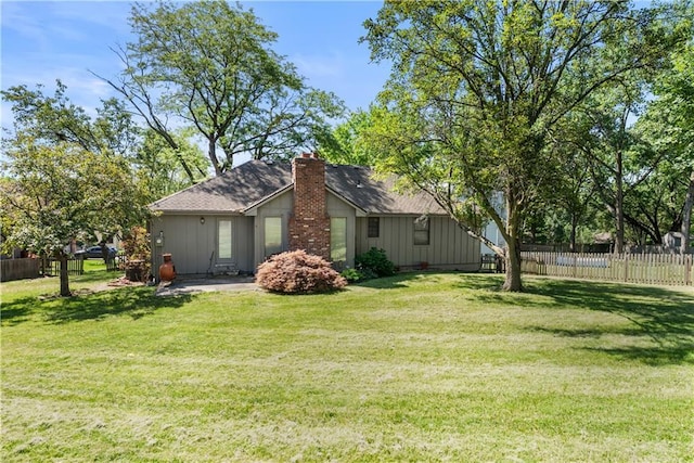 2117 Parker Ct, Blue Springs, MO 64015 - view of home's exterior with a chimney, a shingled roof, and board and batten siding