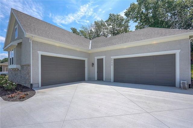6753 Longview St, Shawnee, KS 66218 - view of front of property featuring concrete driveway, an attached garage, stucco siding, and stone siding