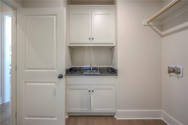 6753 Longview St, Shawnee, KS 66218 - washroom featuring washer hookup, wood finished floors, and cabinet space