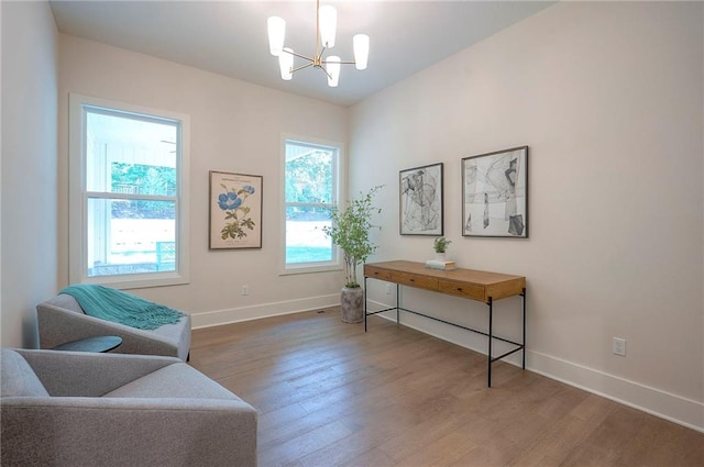 6753 Longview St, Shawnee, KS 66218 - sitting room featuring a chandelier and wood finished floors