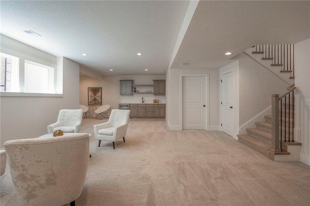 6753 Longview St, Shawnee, KS 66218 - living room with a textured ceiling, stairs, light colored carpet, and recessed lighting