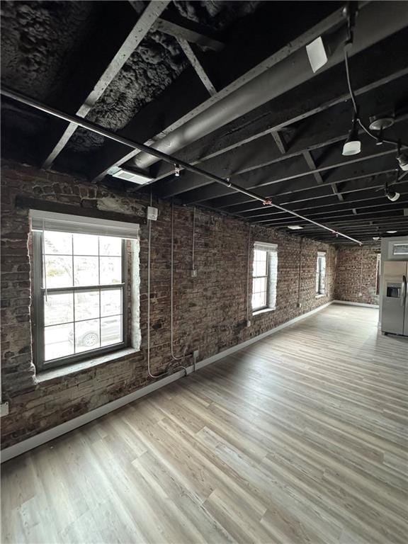 1018 Missouri Ave, Kansas City, MO 64106 - basement featuring brick wall and wood finished floors