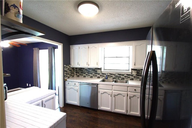 109 SE Rockwood St, Blue Springs, MO 64014 - kitchen with stainless steel dishwasher, white cabinets, a textured ceiling, decorative backsplash, and dark wood-type flooring