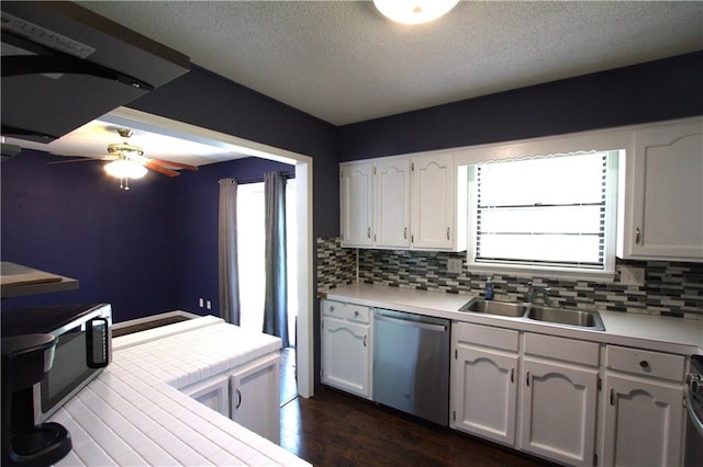 109 SE Rockwood St, Blue Springs, MO 64014 - kitchen featuring stainless steel appliances, backsplash, white cabinets, ceiling fan, and a textured ceiling