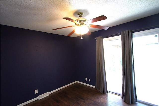 109 SE Rockwood St, Blue Springs, MO 64014 - spare room featuring ceiling fan, dark wood-style floors, and a textured ceiling