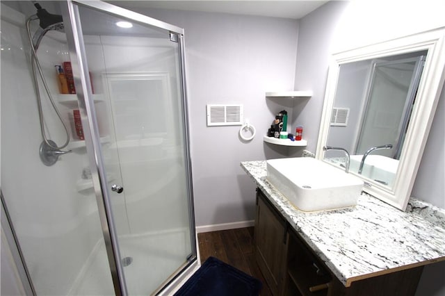 109 SE Rockwood St, Blue Springs, MO 64014 - bathroom featuring wood finished floors, vanity, and a stall shower