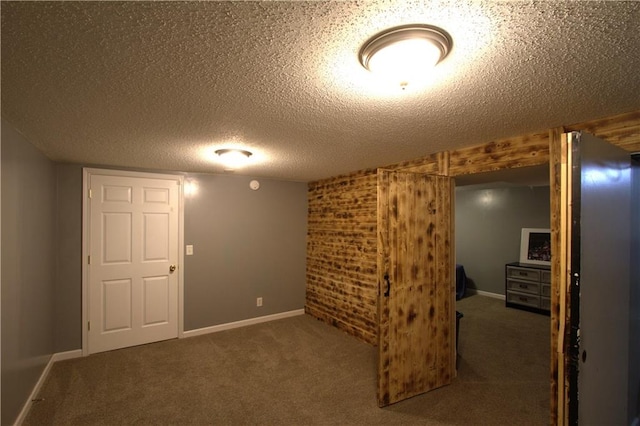 109 SE Rockwood St, Blue Springs, MO 64014 - finished below grade area featuring a textured ceiling, carpet flooring, and brick wall
