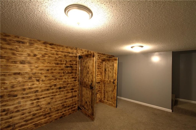 109 SE Rockwood St, Blue Springs, MO 64014 - finished below grade area featuring wooden walls, a textured ceiling, and carpet flooring