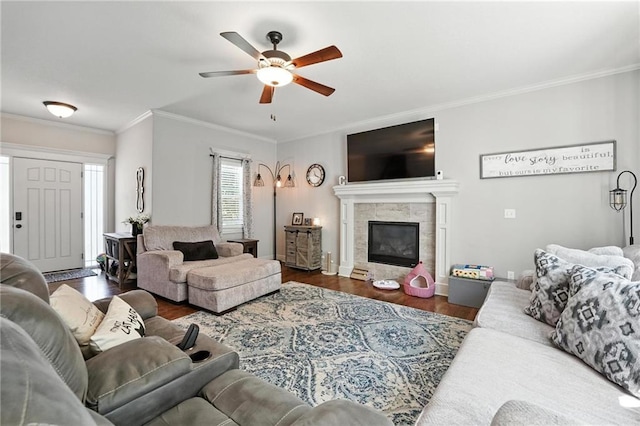 1016 SE Forest Ridge Ct, Blue Springs, MO 64014 - living room with a ceiling fan, crown molding, wood finished floors, and a tiled fireplace