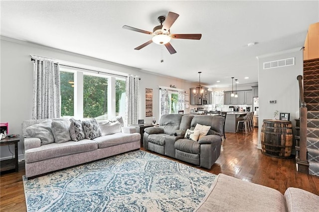 1016 SE Forest Ridge Ct, Blue Springs, MO 64014 - living area with ceiling fan, ornamental molding, dark wood-type flooring, a chandelier, and recessed lighting
