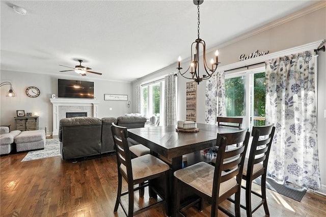 1016 SE Forest Ridge Ct, Blue Springs, MO 64014 - dining area featuring ceiling fan, a chandelier, dark wood finished floors, a fireplace, and ornamental molding