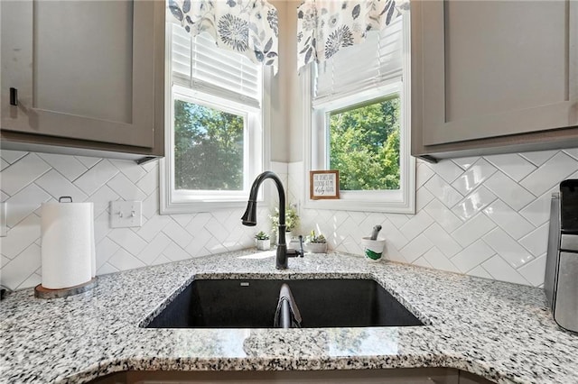 1016 SE Forest Ridge Ct, Blue Springs, MO 64014 - kitchen with tasteful backsplash, light stone countertops, and gray cabinetry