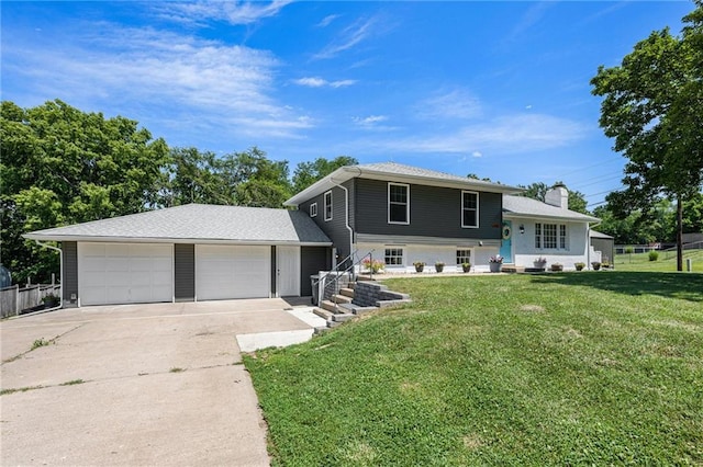 1806 E 125th St, Kansas City, MO 64146 - tri-level home featuring driveway, an attached garage, a front yard, and a chimney