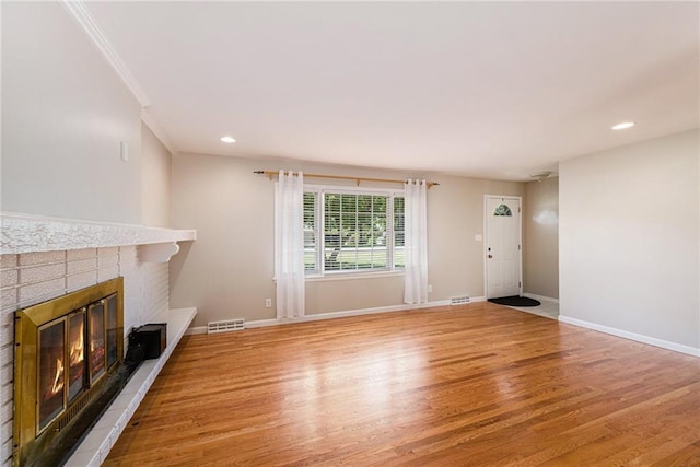 1806 E 125th St, Kansas City, MO 64146 - unfurnished living room with wood finished floors, a fireplace, recessed lighting, and ornamental molding