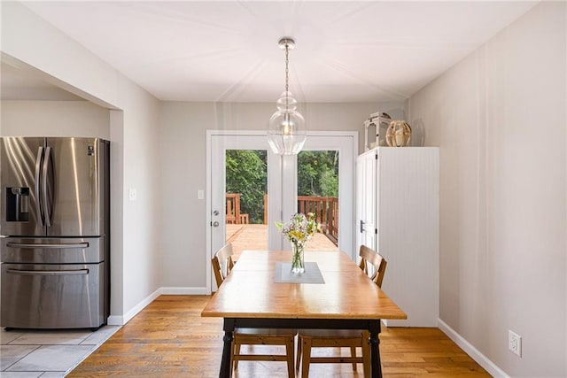 1806 E 125th St, Kansas City, MO 64146 - dining room with light wood finished floors and baseboards