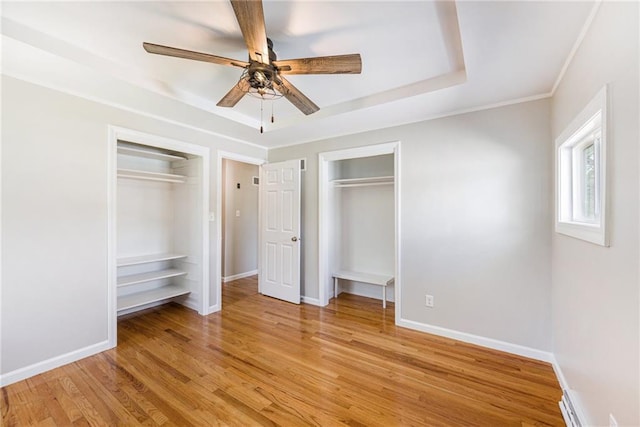 1806 E 125th St, Kansas City, MO 64146 - unfurnished bedroom featuring multiple closets, light wood-style flooring, a ceiling fan, and ornamental molding