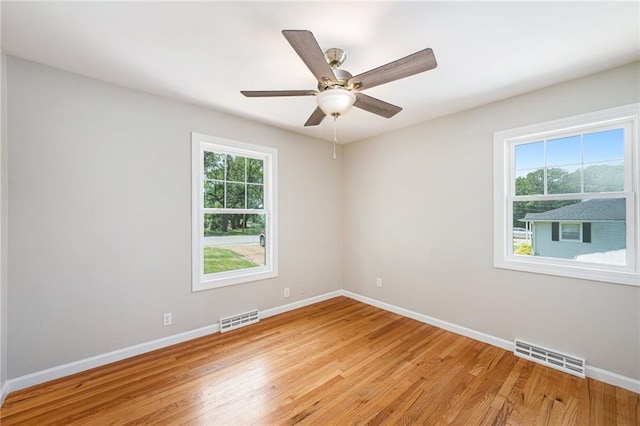 1806 E 125th St, Kansas City, MO 64146 - empty room with light wood-style floors and ceiling fan