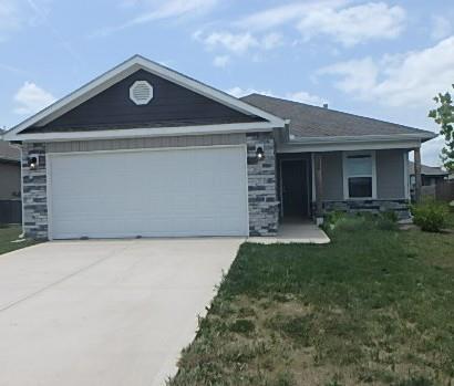 622 N Pecan St, Gardner, KS 66030 - ranch-style house with driveway, an attached garage, a front yard, and stone siding