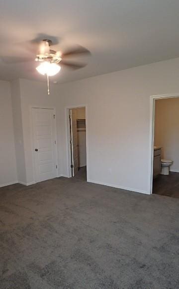 622 N Pecan St, Gardner, KS 66030 - empty room featuring a ceiling fan and dark colored carpet