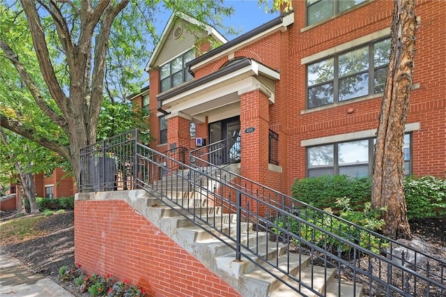 435 W 9th St Unit 204, Kansas City, MO 64105 - view of front facade featuring stairs, brick siding, and a porch