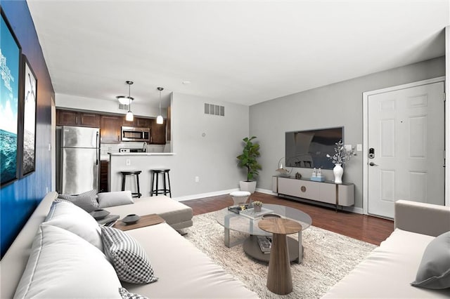 435 W 9th St Unit 204, Kansas City, MO 64105 - living room featuring dark wood finished floors and baseboards