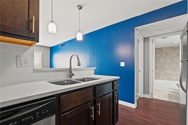 435 W 9th St Unit 204, Kansas City, MO 64105 - kitchen featuring dishwashing machine, dark brown cabinetry, light countertops, and decorative light fixtures