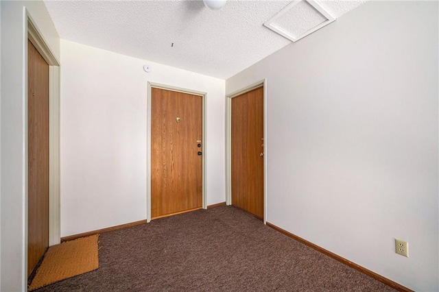 8143 Holmes Rd Unit 202, Kansas City, MO 64131 - carpeted empty room with a textured ceiling and baseboards