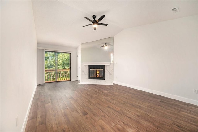8143 Holmes Rd Unit 202, Kansas City, MO 64131 - unfurnished living room featuring a ceiling fan, dark wood-style floors, vaulted ceiling, and a fireplace