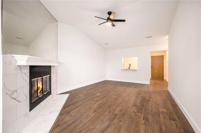 8143 Holmes Rd Unit 202, Kansas City, MO 64131 - unfurnished living room featuring a tile fireplace, a ceiling fan, wood finished floors, and vaulted ceiling
