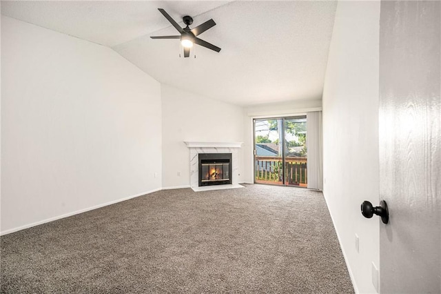 8143 Holmes Rd Unit 202, Kansas City, MO 64131 - unfurnished living room featuring carpet, a high end fireplace, lofted ceiling, and a ceiling fan