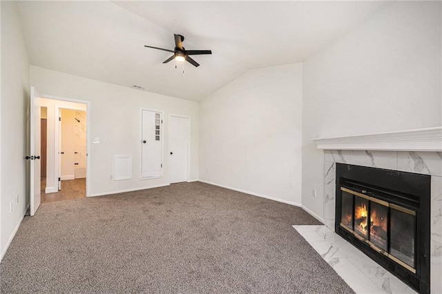 8143 Holmes Rd Unit 202, Kansas City, MO 64131 - unfurnished living room featuring a ceiling fan, vaulted ceiling, a high end fireplace, and carpet floors