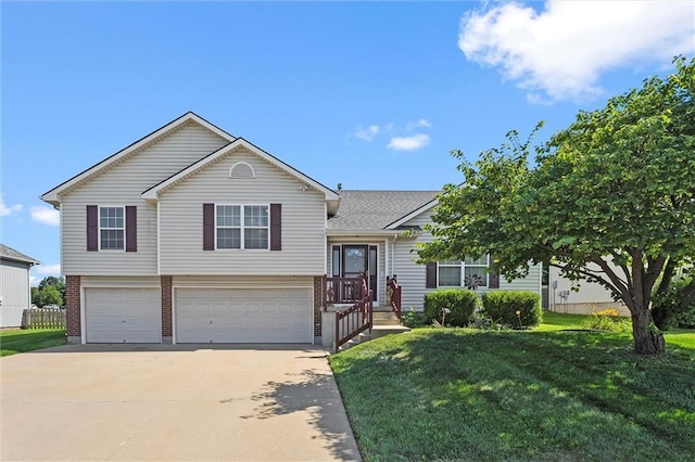 1005 Granada Dr, Raymore, MO 64083 - tri-level home with an attached garage, a front yard, driveway, and brick siding