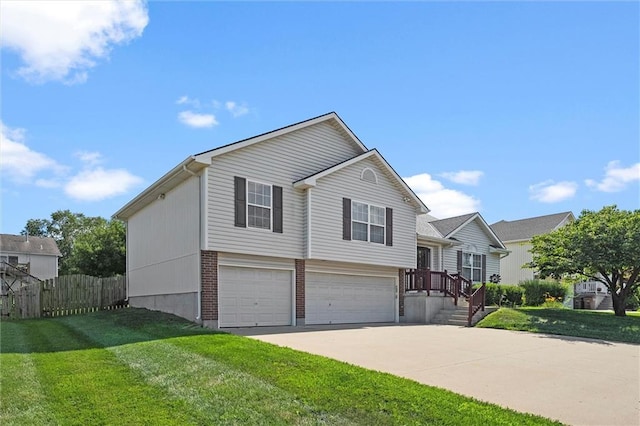 1005 Granada Dr, Raymore, MO 64083 - view of front of property featuring a garage, driveway, and brick siding